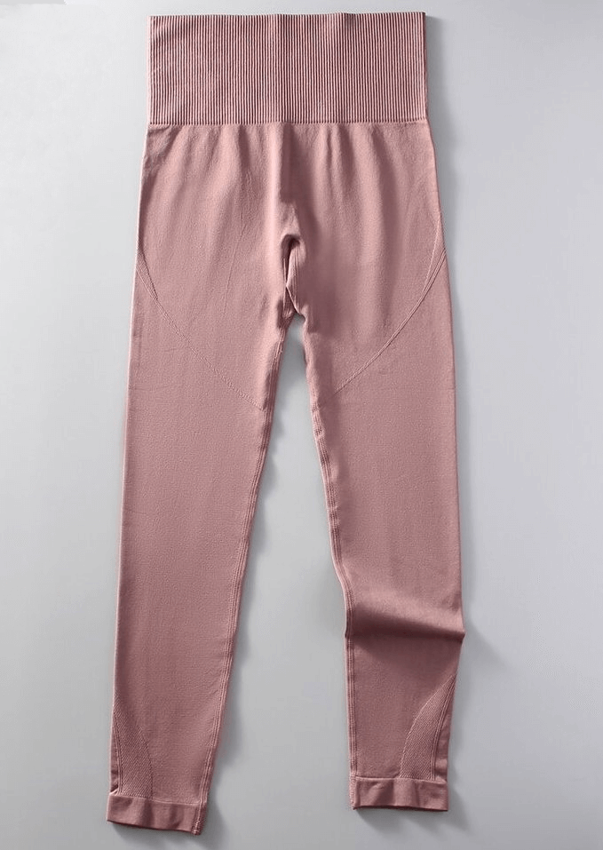 Blush pink women's seamless high waist yoga leggings, full length, made with nylon and spandex for comfort and mobility.